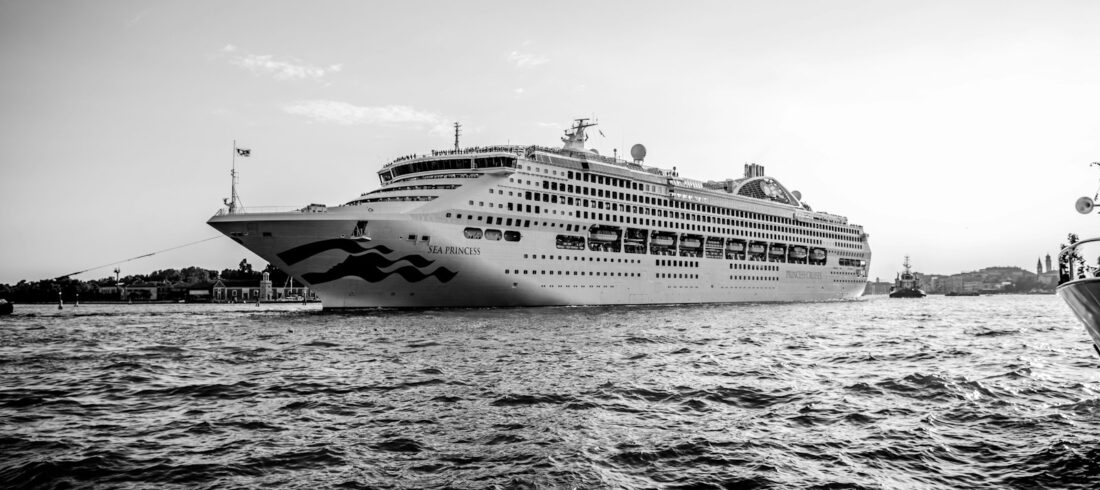 grayscale photo of cruise ship on sea