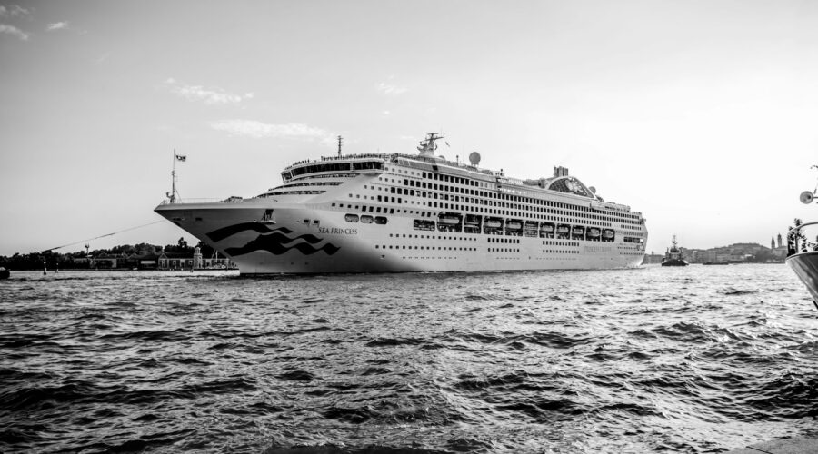 grayscale photo of cruise ship on sea