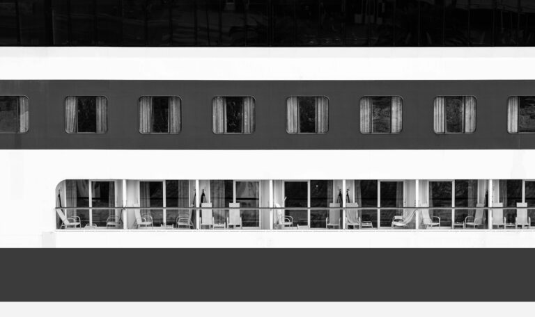 a black and white photo of a balcony on a cruise ship